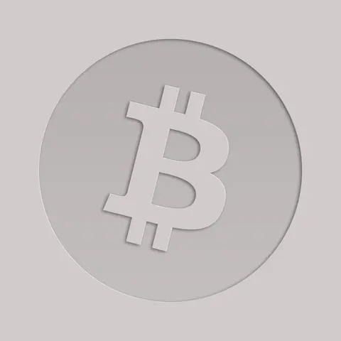 Silver Bitcoin symbol embossed on a metal surface